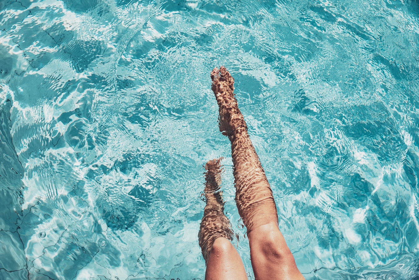 Person Kicking Feet in Pool - The Great Escape