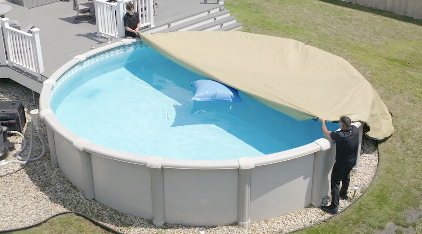 Picture of people putting on winter pool cover